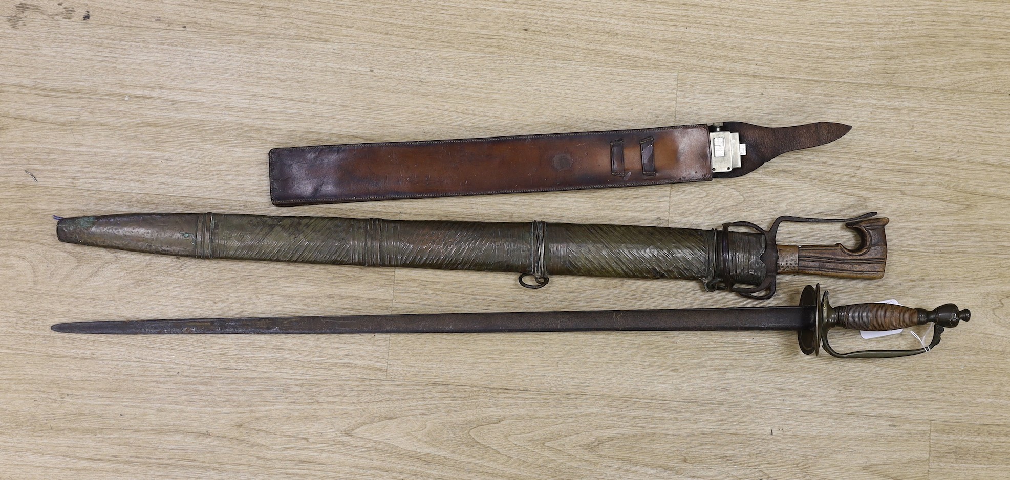 A Moroccan nimcha sword with associated Andrea Ferrara (Scottish) blade and a scabbard together with a court sword and an Aston & Mander Ltd. Mk VI military rule in leather case